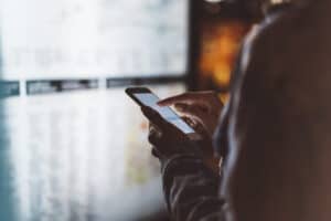 protect smartphone egamers blockchain gaming community from nfts cryptos spyware etc Girl pointing finger on screen smartphone on background light box in night atmospheric city map, hipster using in female hands and texting mobile phone, glitter street lifestyle, tourist planing route