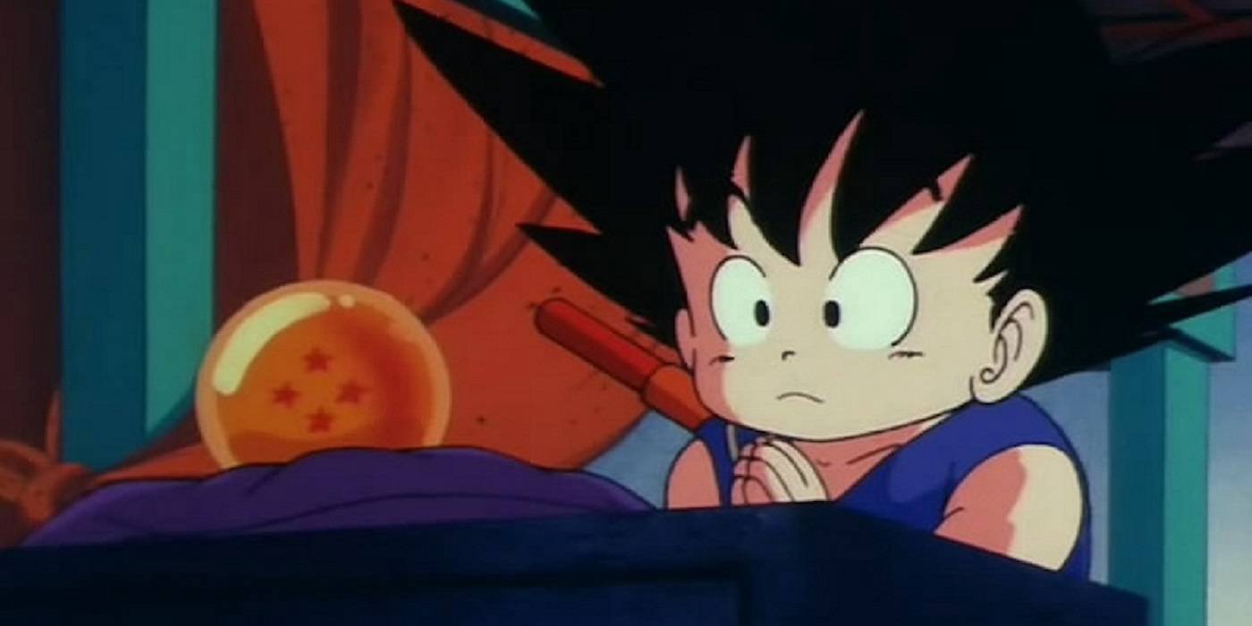 Kid Goku looks apprehensive as he prays to the four star dragon ball.
