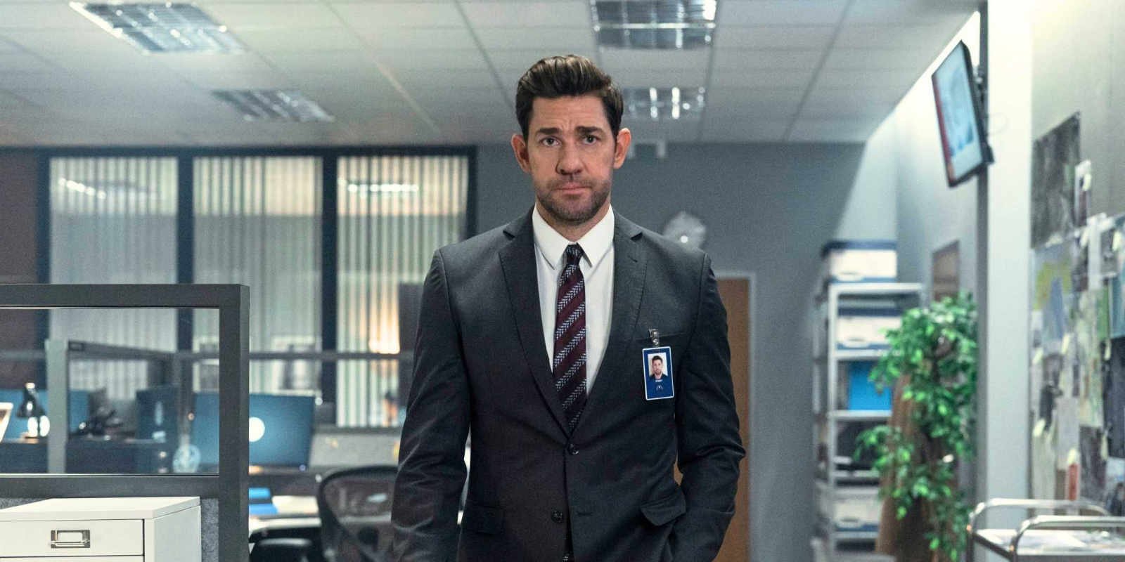 John Krasinski in a suit walking towards the camera in Jack Ryan