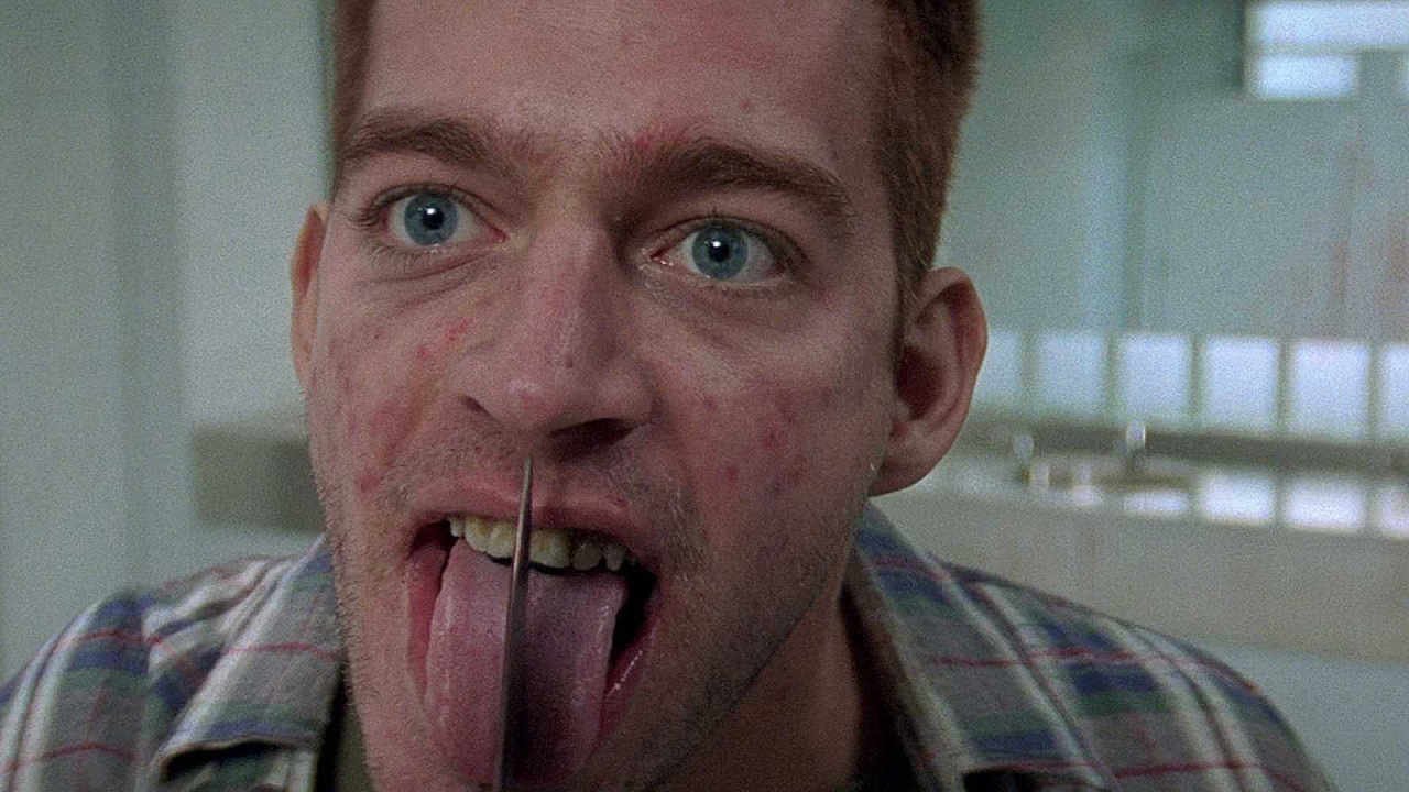 Harry Connick Junior licking a knife blade in Copycat
