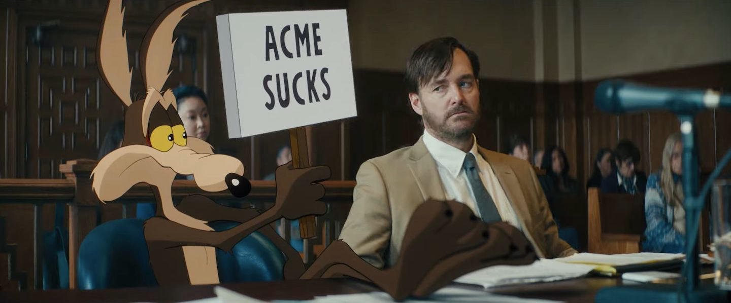 Wile E. Coyote hold a sign that reads "ACME sucks"