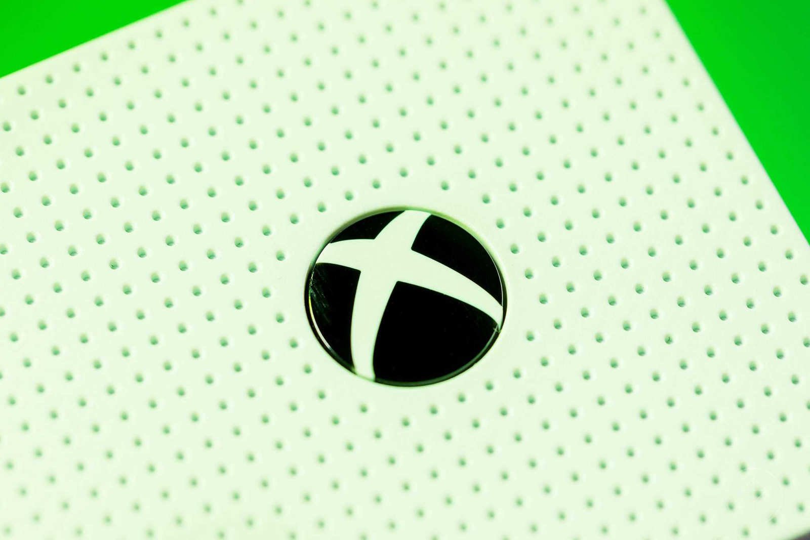 close-up photo of Xbox power button on Xbox One S