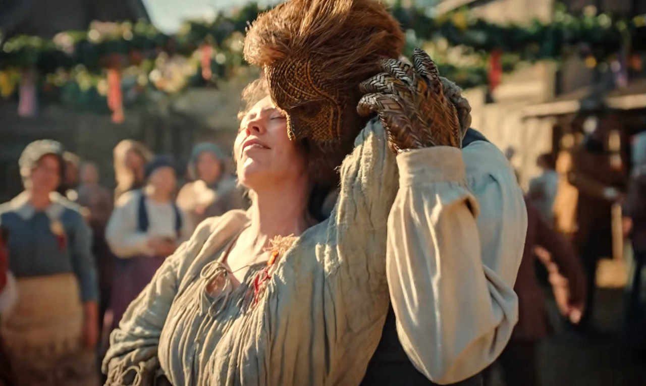 A handsome wicker man nuzzles Olivia Colman in Wicker