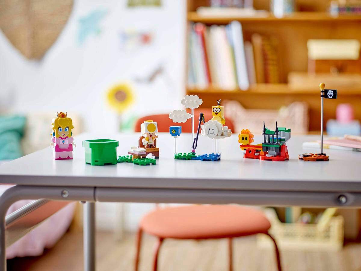 A Nintendo Super Mario LEGO set featuring Princess Peach laid out on a table