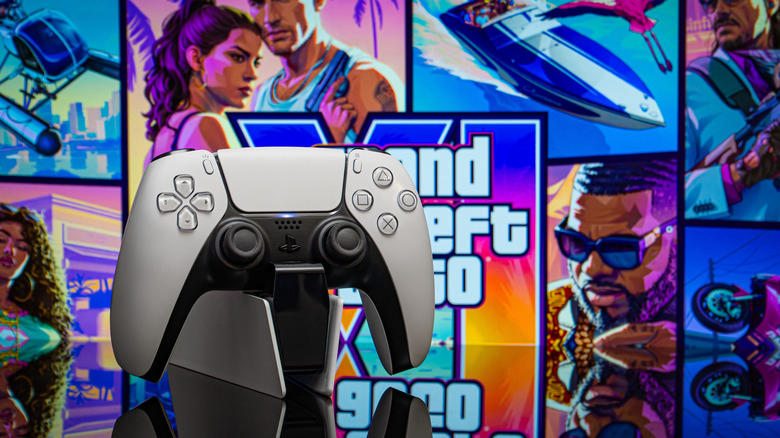 A DualSense PS5 controller on a stand, placed in front of GTA 6 box art.